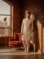 Close‑up: Close-up of resham embroidery on ivory silk sherwani sleeve