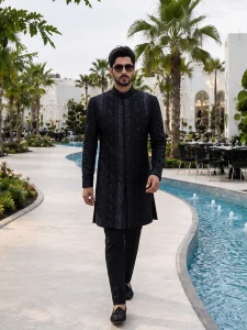 Black sherwani with handmade digital thread embroidery for groom wedding wear.