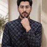 Black sherwani with digital thread handmade embroidery for men’s wedding and formal wear.