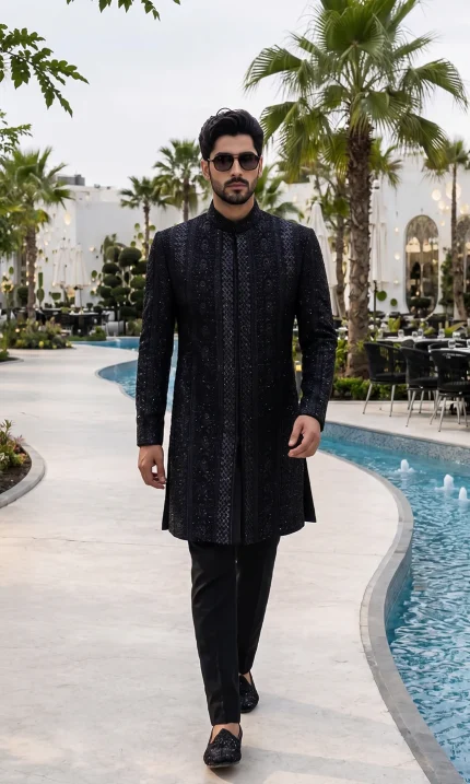 Black sherwani with handmade digital thread embroidery for groom wedding wear.